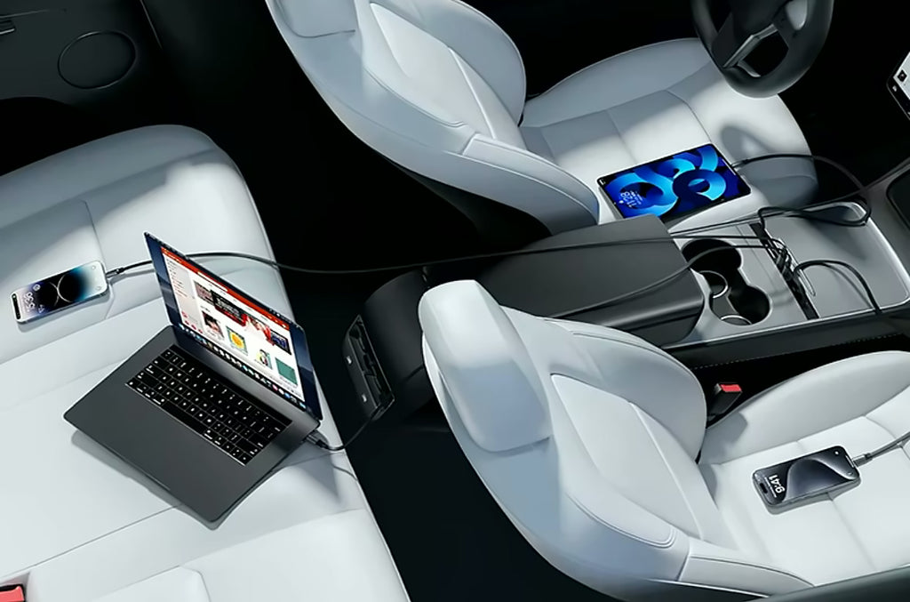 Hub charging a phone, tablet and laptop in a Tesla