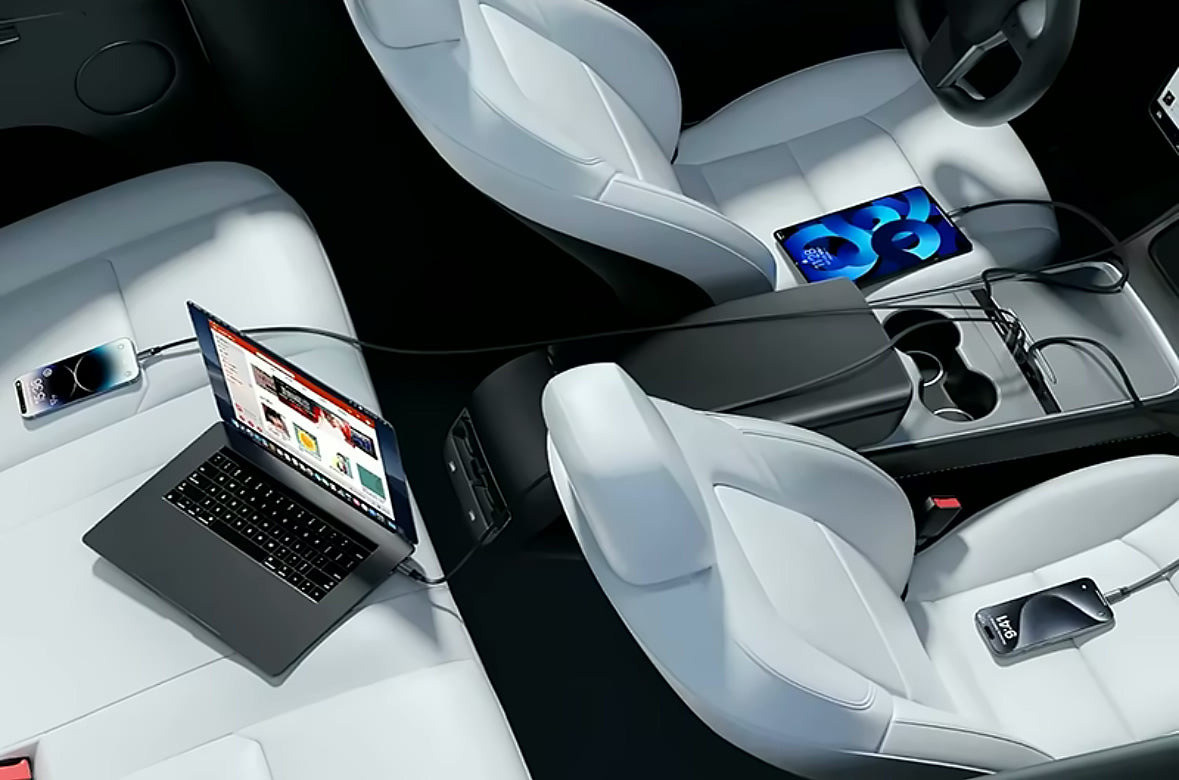 Hub charging a phone, tablet and laptop in a Tesla